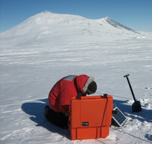 Brian Bonnett deploys a MEVO station with Mt. Erebus in the background